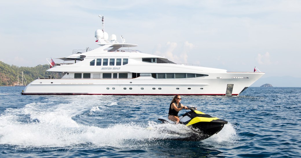 charter guest tries out jetski as superyacht ‘Seven Sins’ anchors nearby