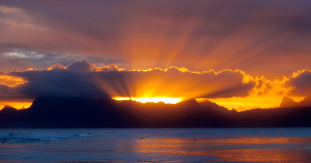 Tahiti is famous for its breathtaking sunsets, best viewed from a charter yacht