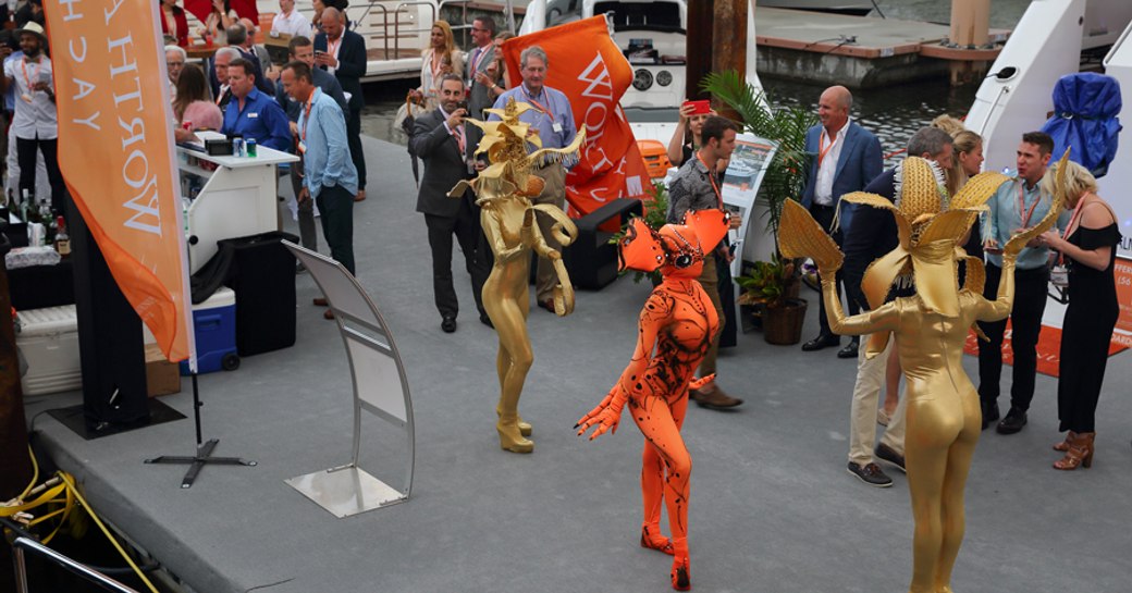 Group of three female entertainers at yacht stand during Palm Beach International Boat Show.