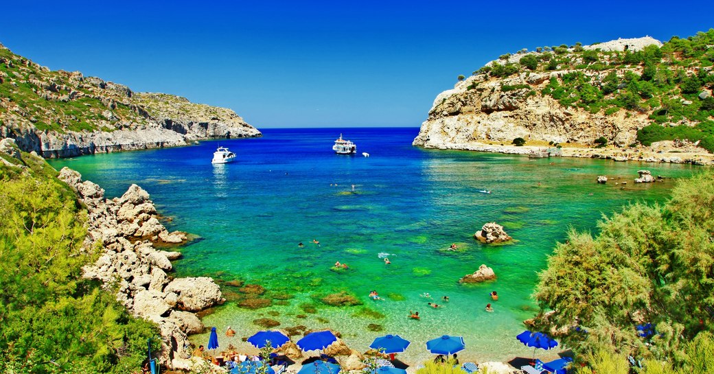 Secluded bay in Rhodes with rock formations along coastline