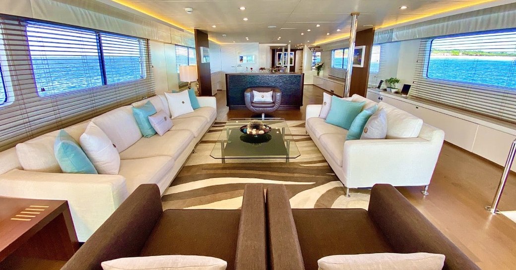 Bright interiors with sofas, armchairs and table on superyacht LIONSHARE