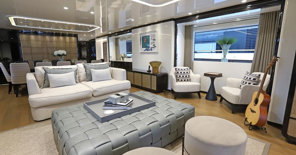 Master cabin with central berth and seating area onboard charter yacht ANDIAMO