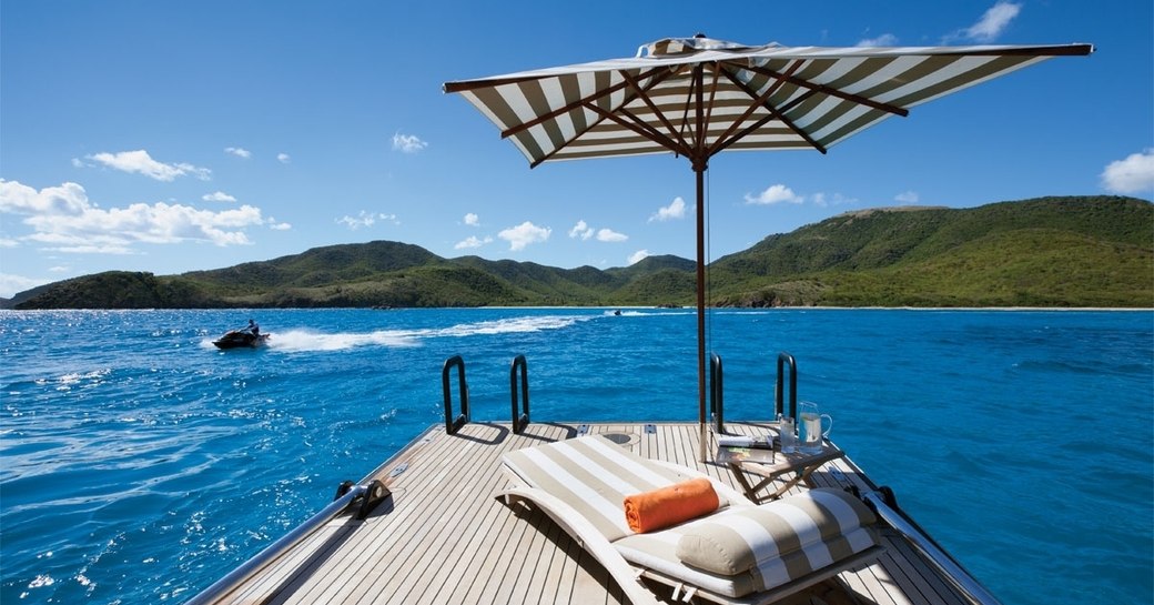 sun lounger lined up on reclining aft deck boarding platform aboard sailing yacht TIARA 