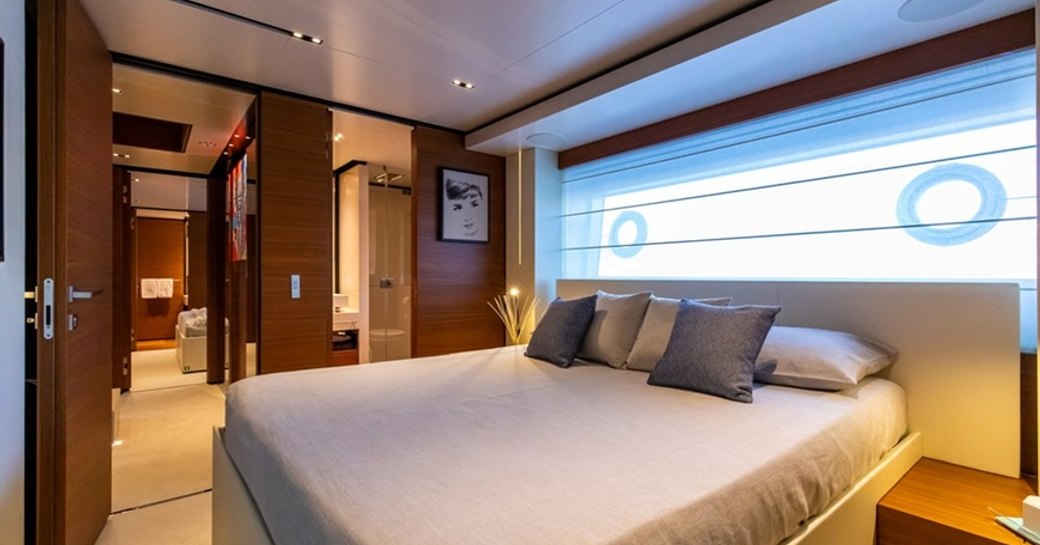 Guest cabin onboard Ferretti yacht charter 30m PENELOPE, central berth and view through doors to opposite cabin