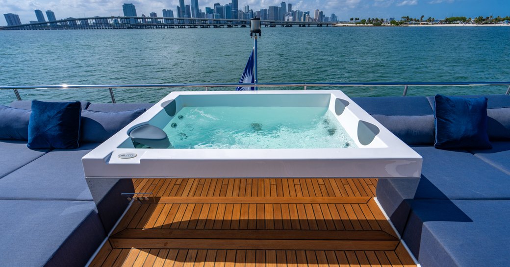 Overview of the Jacuzzi onboard charter yacht CARPE DIEM with surrounding blue sun pads