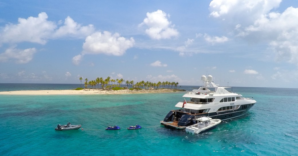 Luxury yacht REBEL with her water toys with Caribbean island in the background