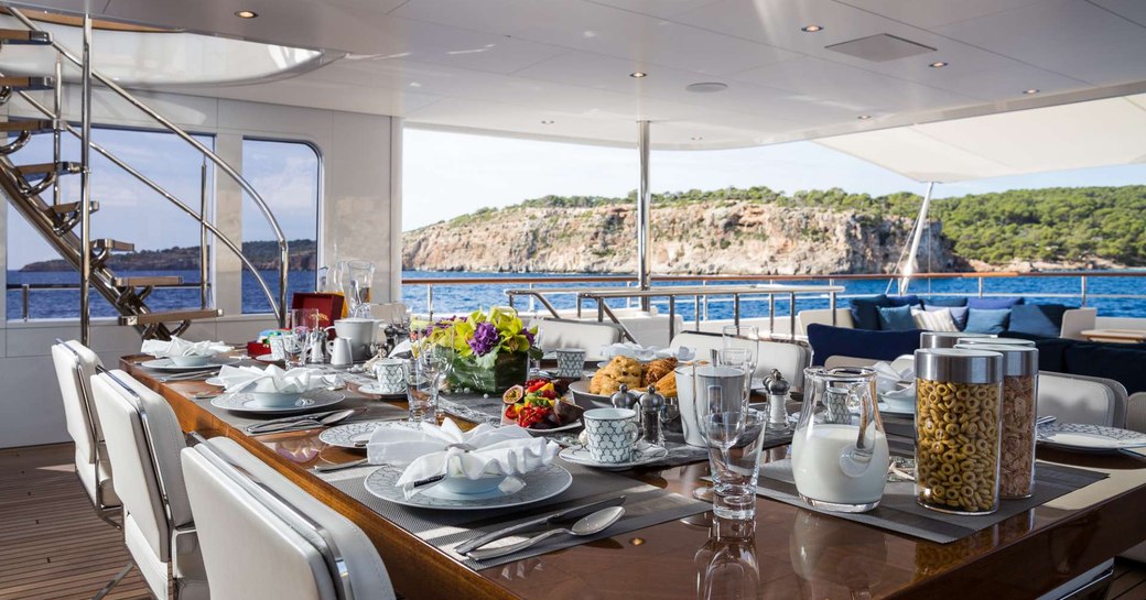 Dining space on aft deck on luxury yacht GO