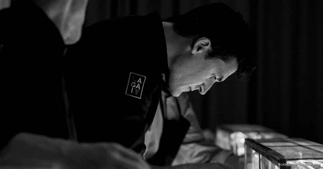 Chef Molina preparing dishes behind the counter in the restaurant 