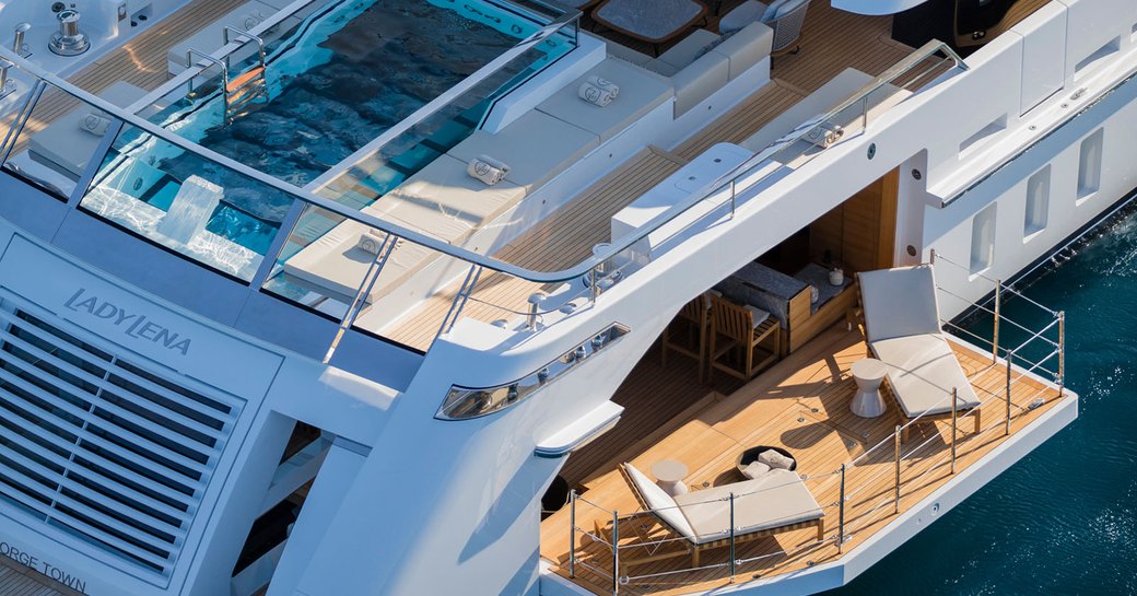 Aerial shot of glass bottom swimming pool and side deck of superyacht Christina O 