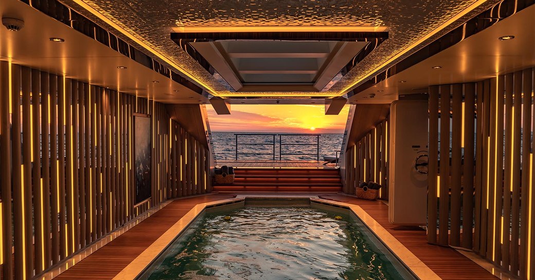 pool on superyacht tatiana, with sunset view in background