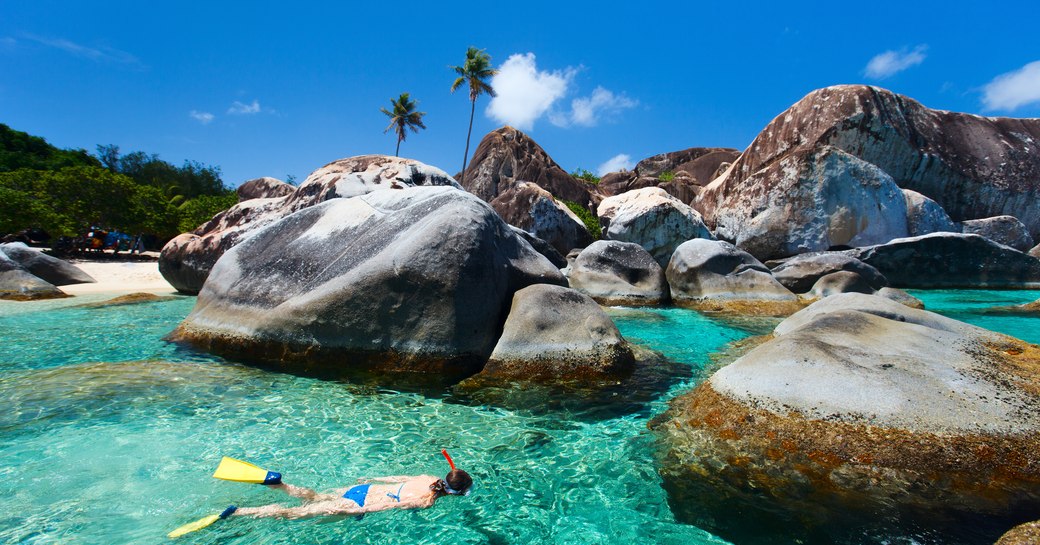 Woman snorkels in the Baths in Virgin Gorda, the British Virgin Islands