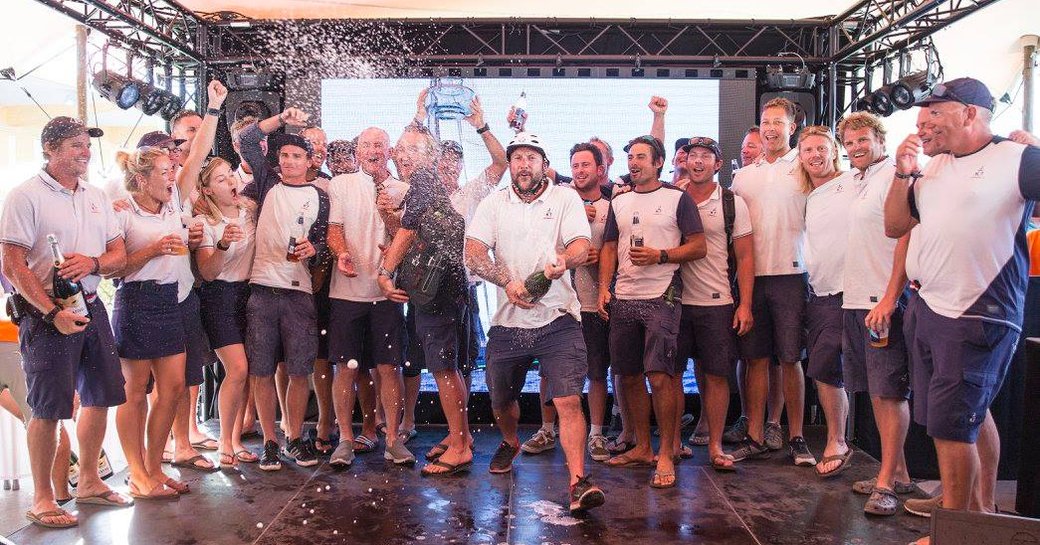 the crew aboard VELSHEDA spray champagne after winning the Superyacht Cup Palma 2018 