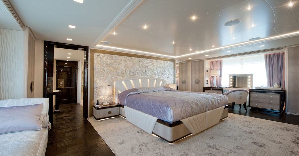 Master cabin onboard boat charter SCORPION, central berth with large window an seating area