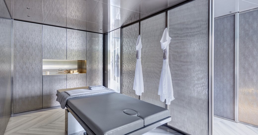 A silver massage bed surrounded by silver decor on board superyacht SAVANNAH