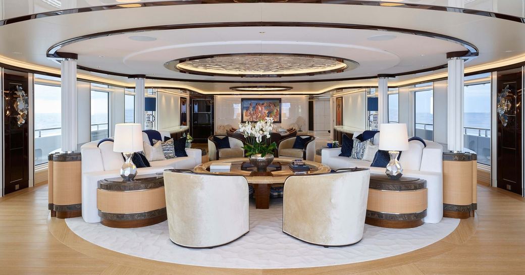 Interior lounge area surrounded by large windows onboard superyacht charter EXCELLENCE