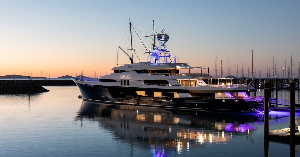 Superyacht illuminated at sea at Coral Sea Marina Resort