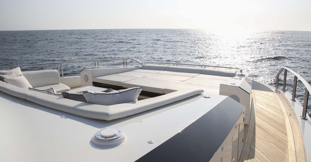 Foredeck seating and sun pad area on board charter yacht O