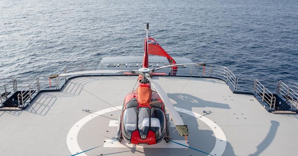 Helicopter and landing pad on board charter yacht OCTOPUS