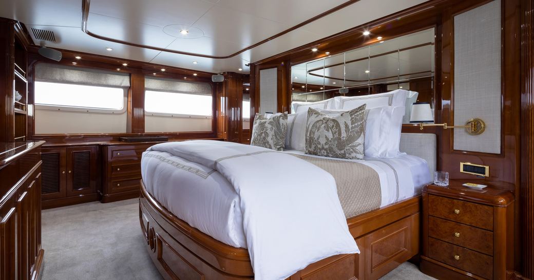 Guest cabin onboard yacht charter SERENO with central berth and two windows