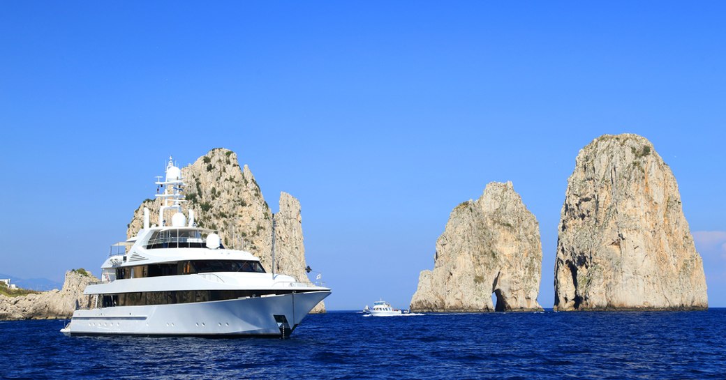 superyacht cruises in capri next to faraglioni rocks