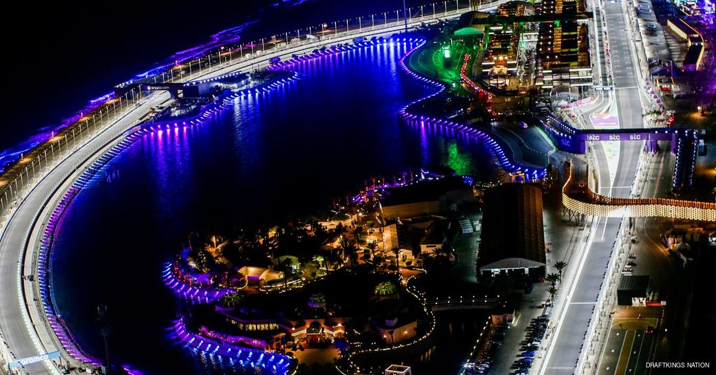 Overhead view of Jeddah Corniche Circuit at night, bright lights surround circuit.