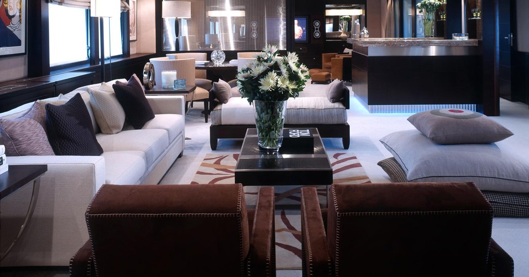 Interior of Illusion I yacht - showing sofas and table with flowers on