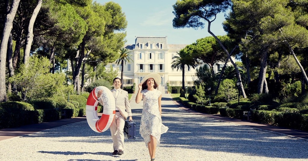 Hotel du cap eden roc, guests standing on driveway infront of building 