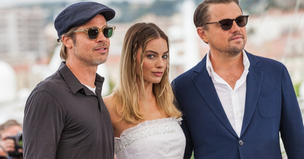 margot robbie, brad pitt and leonardo dicaprio in front of yachts in the marina at cannes