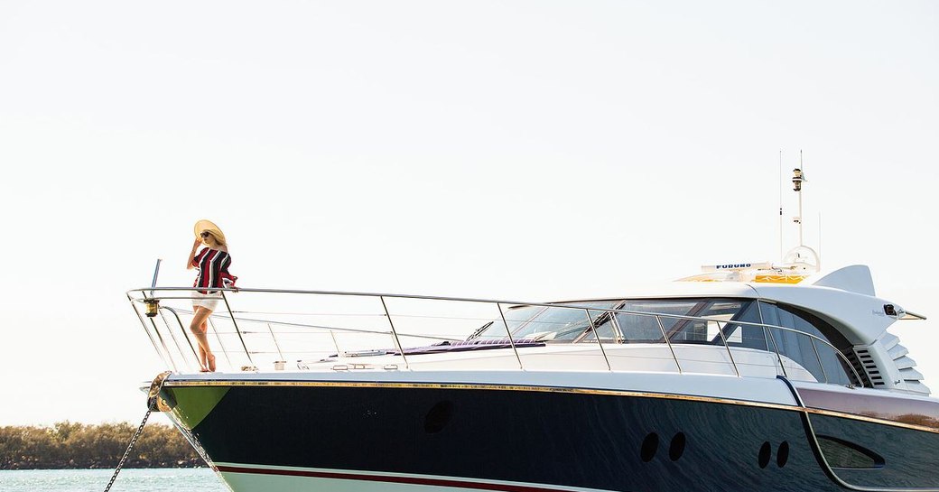 charter guest takes in views of Australia's Gold Coast from the foredeck of charter yacht ‘Crystal Blue’ 