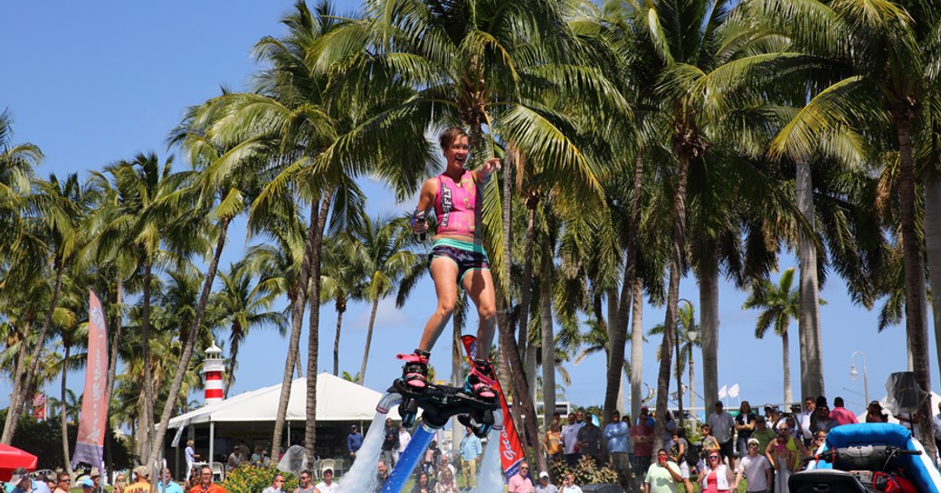 Woman demonstrating water toy at Palm Beach Boat Show