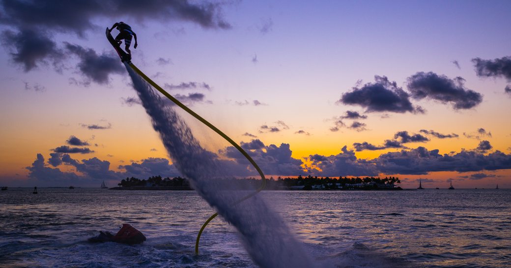 A man on a hoverboard at dusk