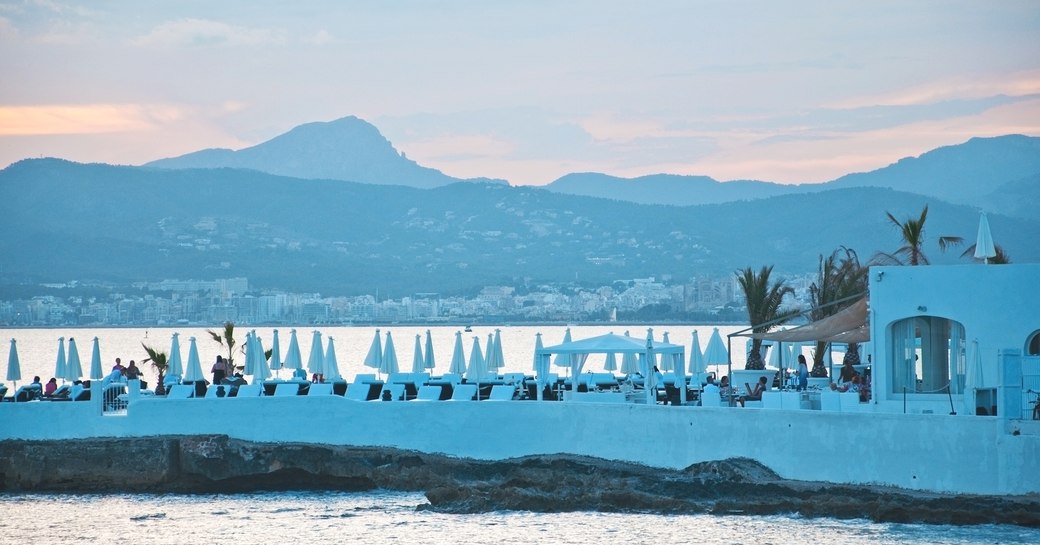 beautiful scenery over Palma bay with Puro Beach Club white parasols on a sunny summer day 