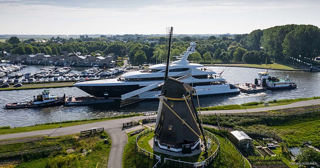 podium superyacht passes by windmills of the netherlands