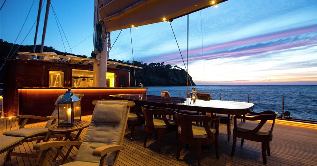 alfresco dining table at sunset on board superyacht SATORI