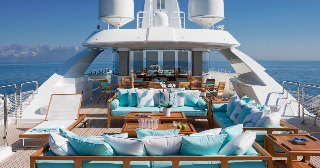 Blue and white furnishings on board the exterior of superyacht Ramble On Rose