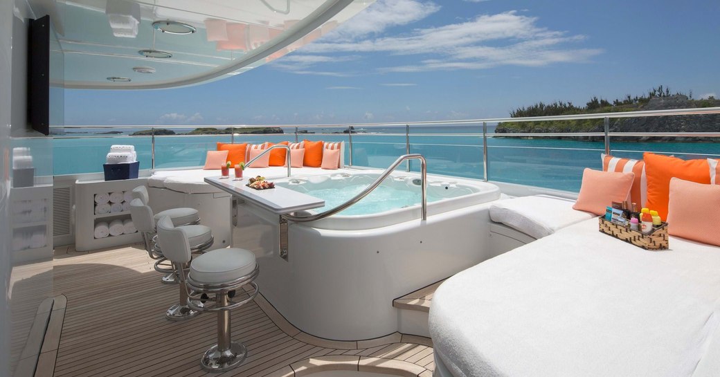 the 6 person jacuzzi of charter yacht time for us with a stunning view of the Bahas in the background