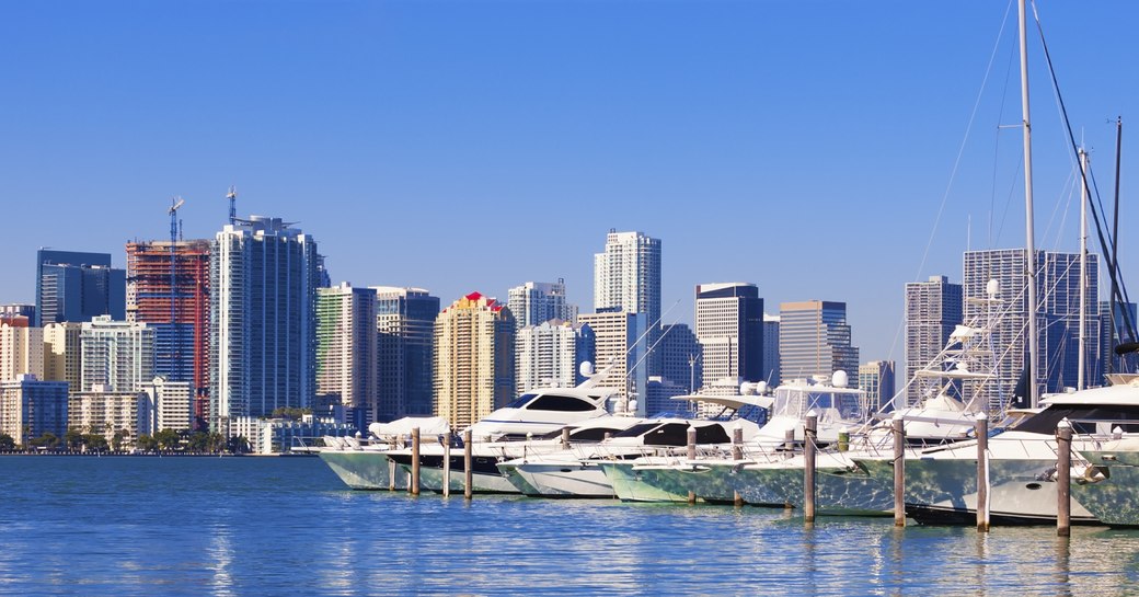 yachts lined up in Miami South Beach Marina with city skyline in the background  