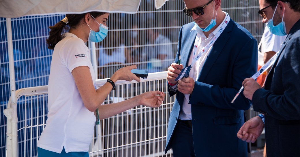 An MYS official checks a show goer's vaccination pass