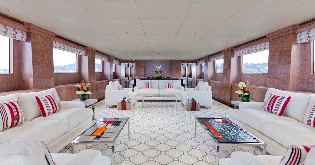 Main salon on motor yacht ELEMENT, with tall windows and cream colours