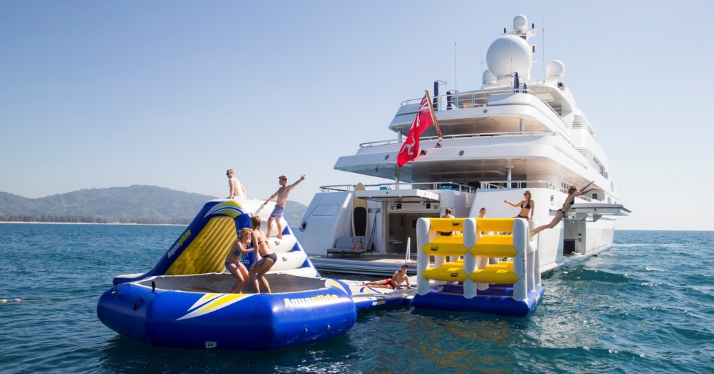 Charter guests playing on yacht Titania's waterpark