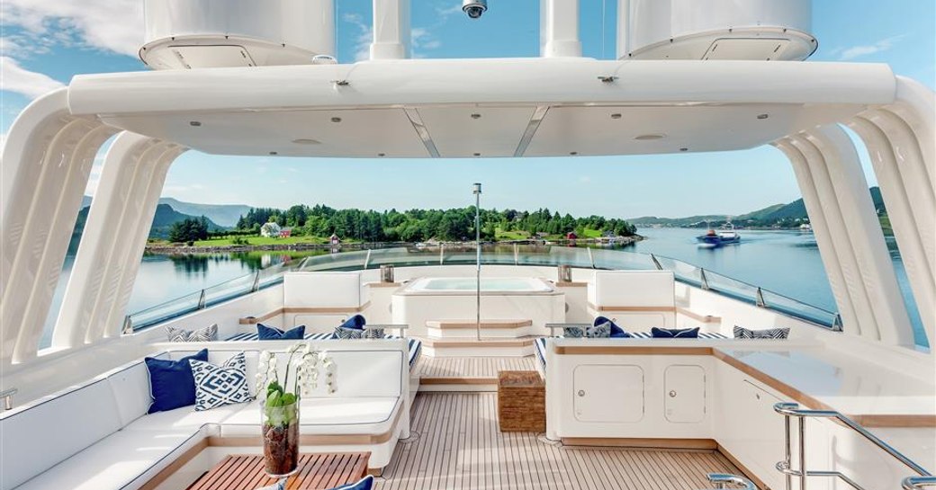 the spacious and inviting sun deck of charter yacht fabulous character with sumptuous seating and elevated jacuzzi