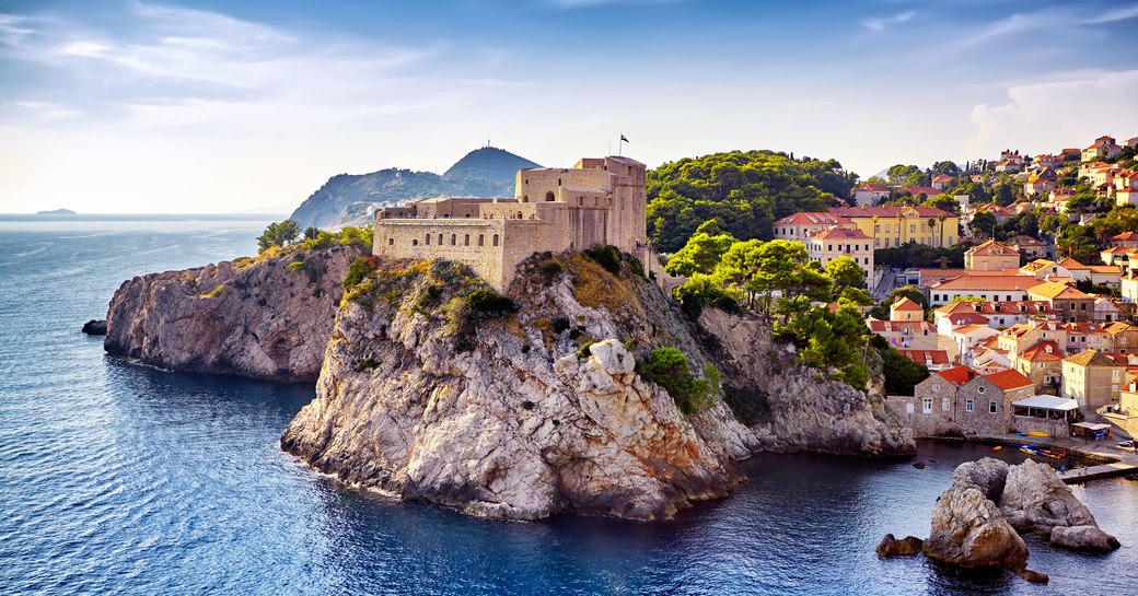 Marina in Croatia with castle on cliff