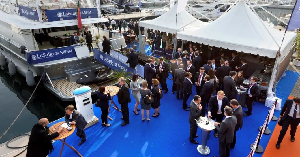 Participants of MIPIM around luxury yacht at the event in Cannes