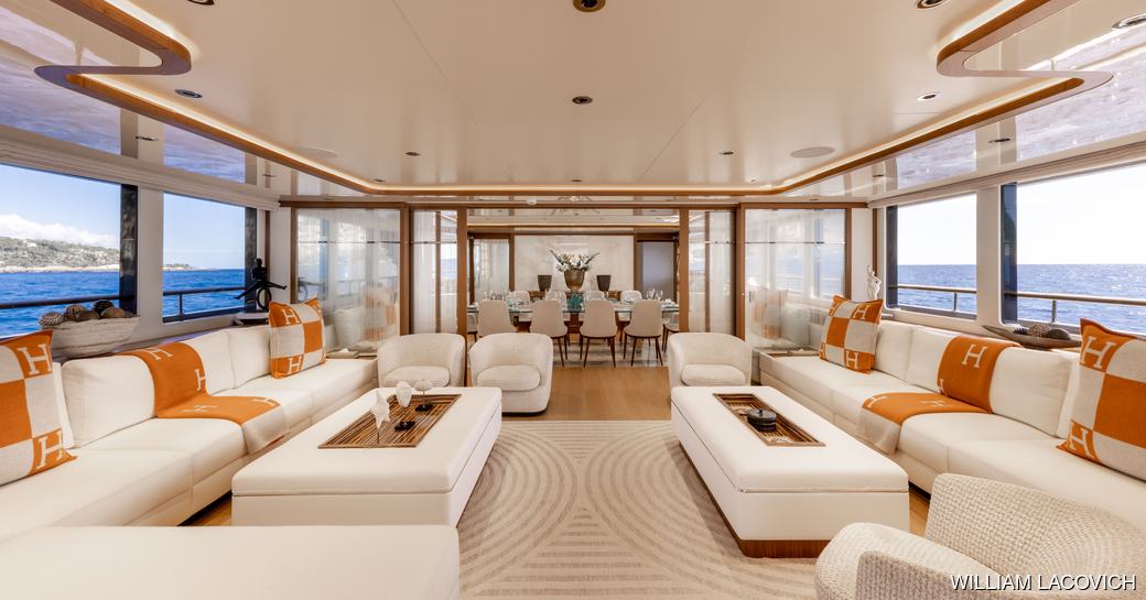 Charter yacht SOLAFIDE main salon with lounge area and large windows