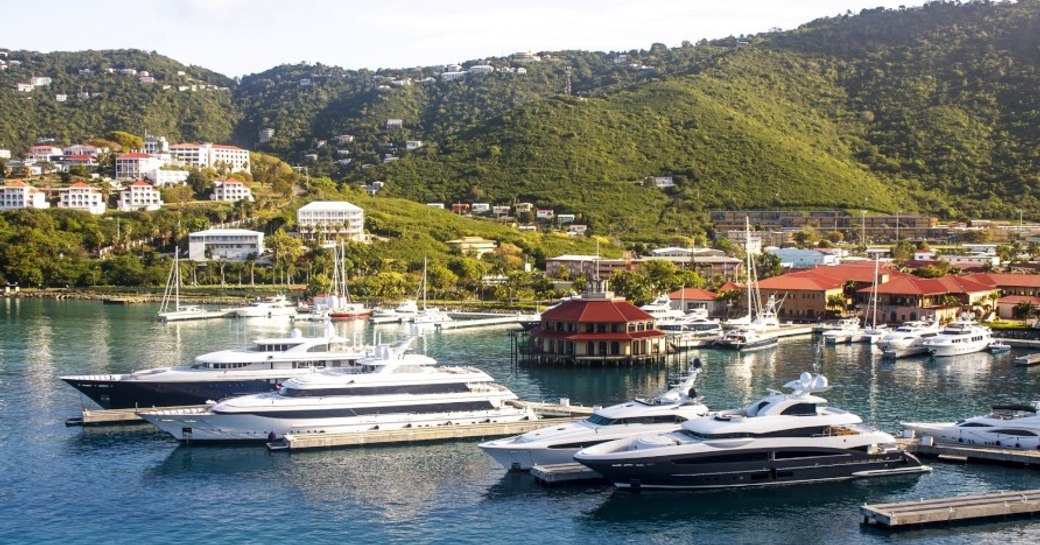 A daytime photo of superyachts gathered in Yacht Haven Grande Marina, St Thomas