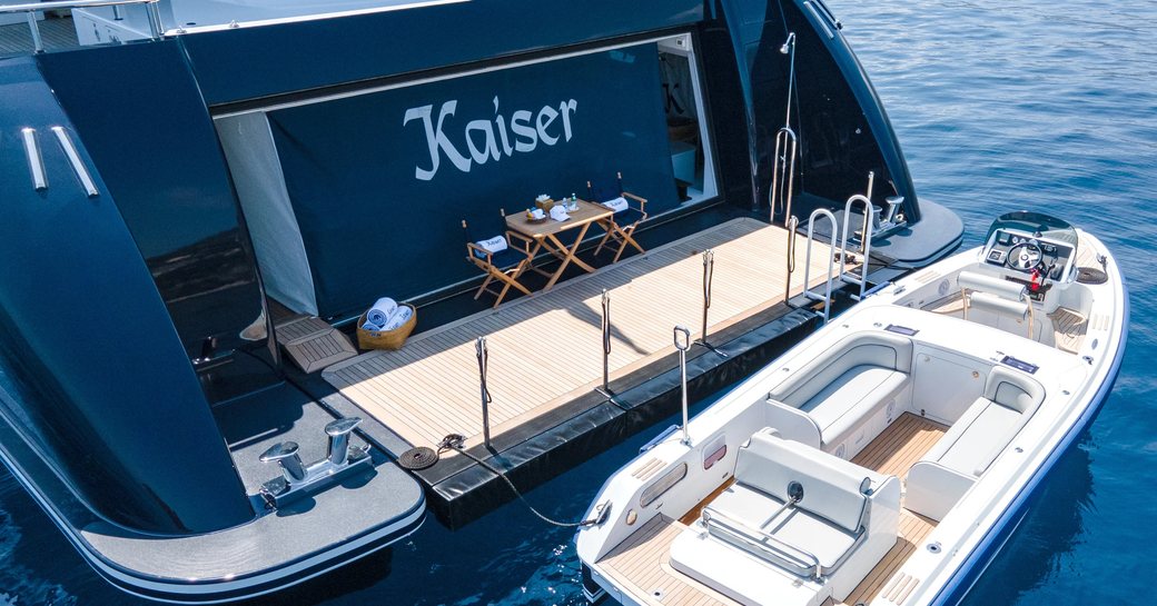 Nameplate, swim platform and adjacent tender of charter yacht KAISER