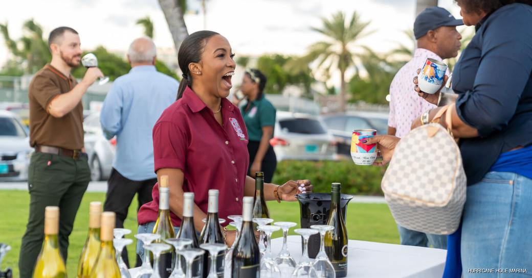 A drinks server at the Hurricane Hole marina having a laugh with visitors