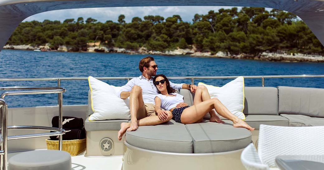 a couple enjoying some quality time together while on their luxury yacht charter in the caribbean for some well deserved rest and relaxation in a stress and risk free zone