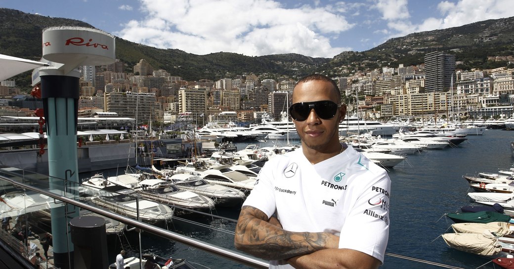 Lewis Hamilton in Monaco standing in front of harbour