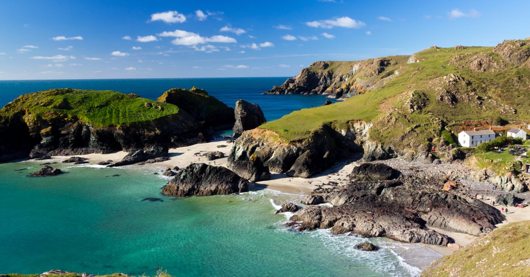 kynance cove in cornwall, bright blue sea and pretty sandy beach